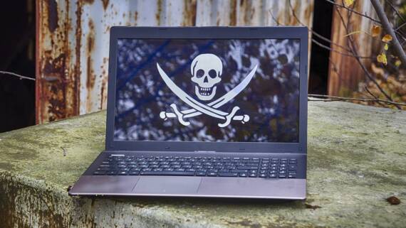 Ilustracija laptopa sa piratskom zastavom na ekranu